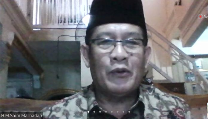 Ketua MUI Kota Palembang, H. Saim Marhadan, membabar tata cara penyembelihan hewan kurban di masa pandemi dalam webinar yang digelar KAGAMA Sumsel. Foto: Ist